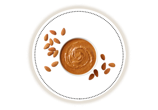 Almond butter and almonds on white background