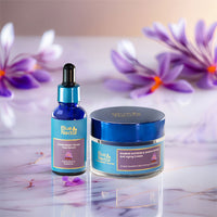 Blue Nectar Kumkumadi oil and anti-aging cream with saffron flowers on a glossy surface.