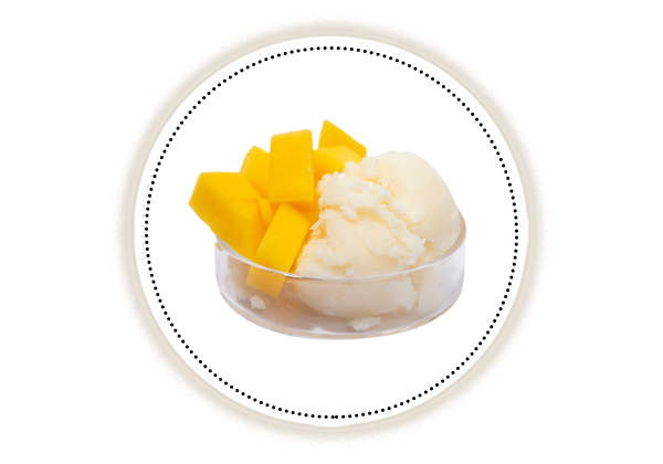 Mango butter and Mango pieces in a glass bowl on white background