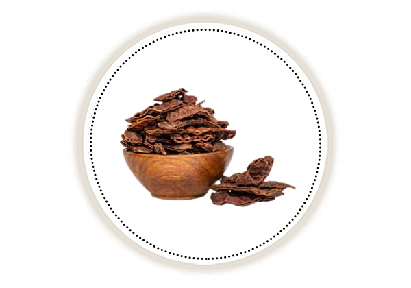 Shikakai in a wooden bowl on white background