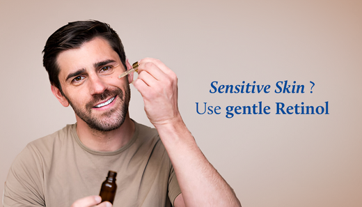 A man applies bakuchi face serum to his cheeks, holding the applicator in one hand and the bottle in the other.