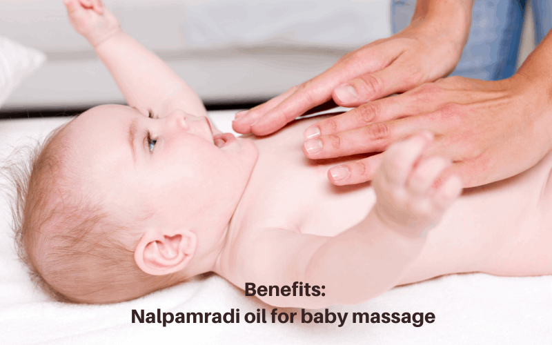 Someone is giving baby a body massage with nalpamradi oil