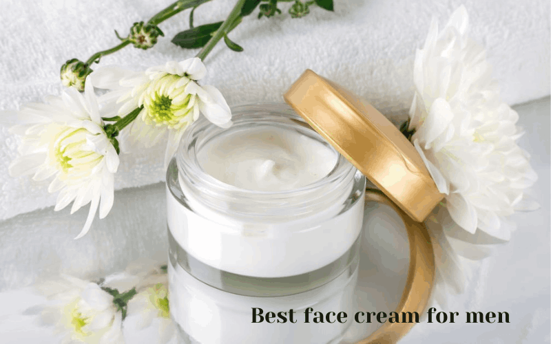 face cream for men,  mirror, flowers placed on white table with towel