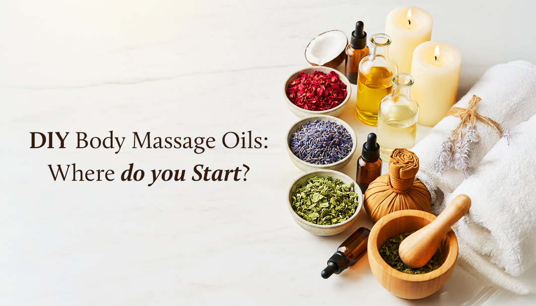 DIY body massage oil setup with glass bottles of oils, dried herbs, dropper bottles, candles, towels, and a wooden mortar and pestle on a white background.