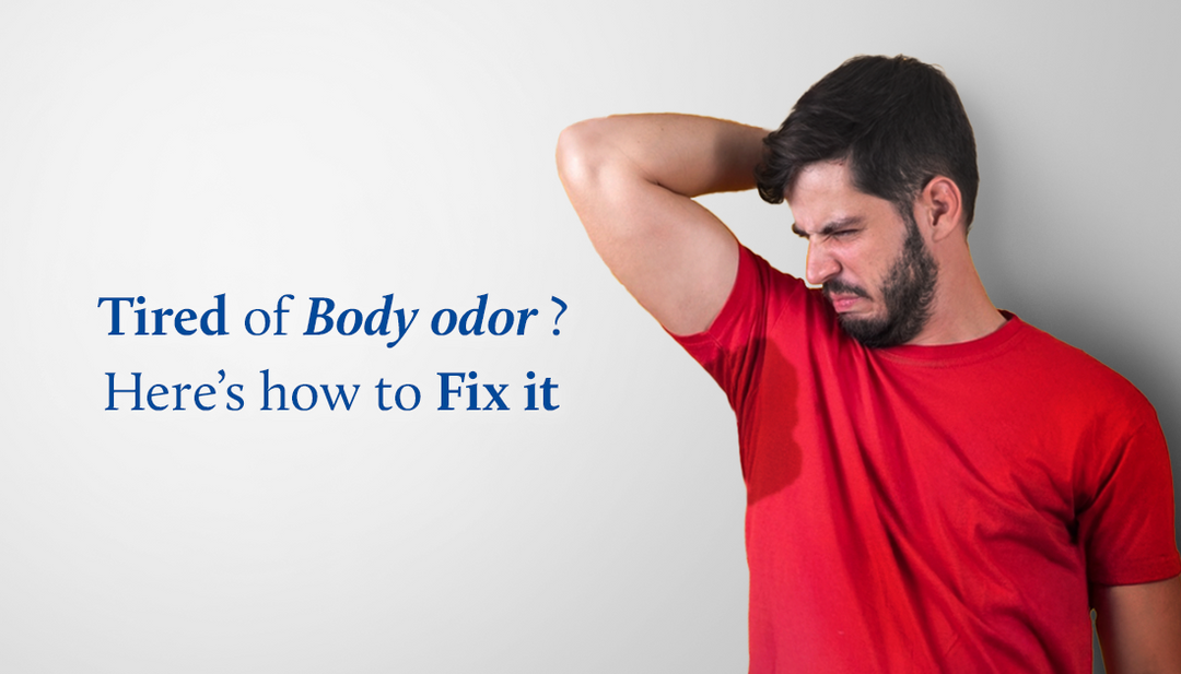 A man is smelling his underarm and making a disgusted expression.