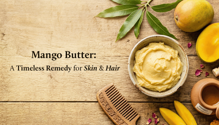 A rustic wooden table displays a bowl of creamy mango butter, ripe mangoes, a wooden comb, and text: "Mango Butter: A Timeless Remedy for Skin & Hair."