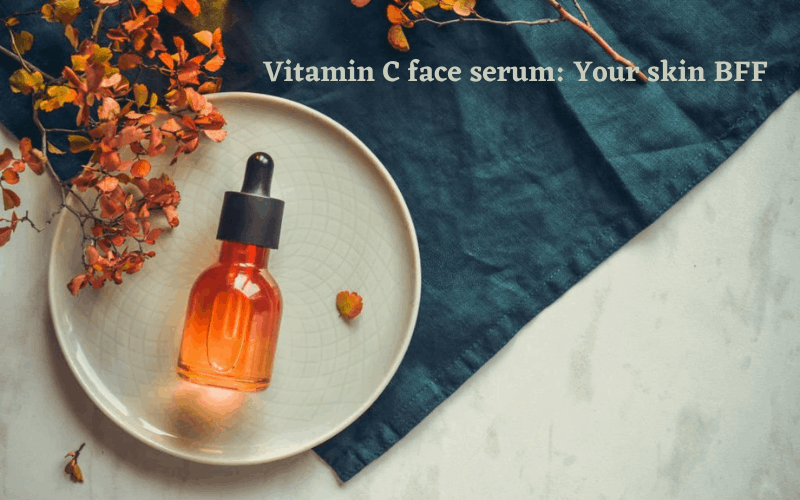 Vitamin c face serum bottle is placed on white plate with some flowers around it 