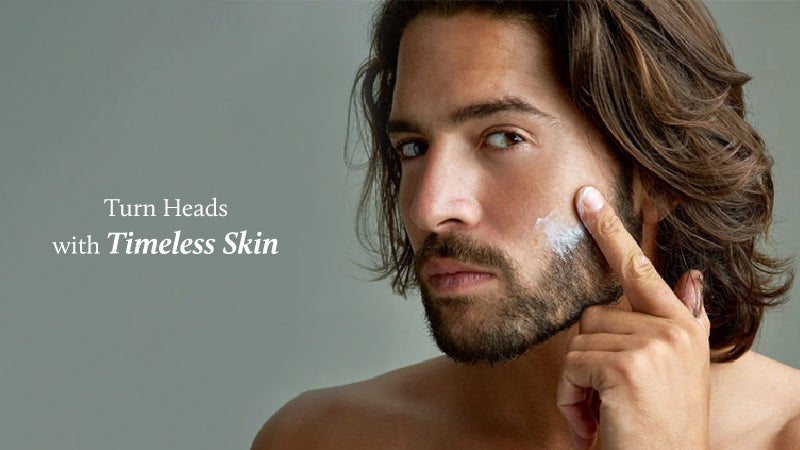 men is applying face cream on his cheeks 