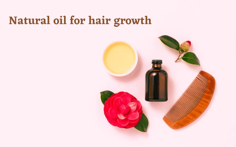 oil for hair growth, comb, flower and hair cream are on table 