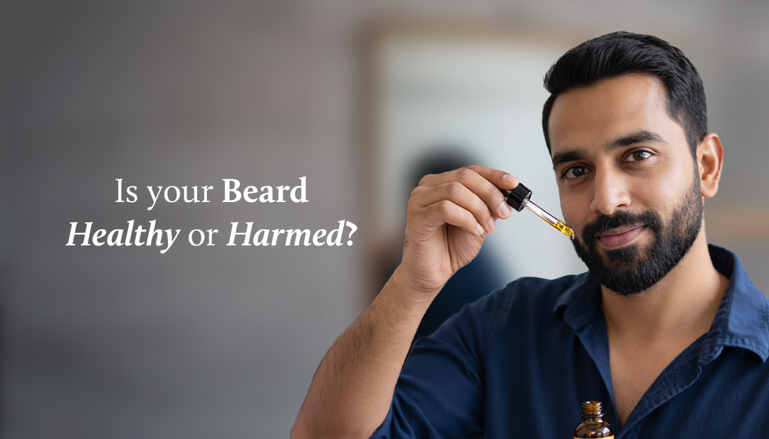 men is applying beard oil on his beard