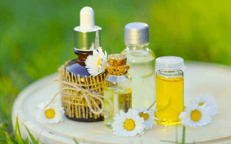 4 essential oils with flowers are on table 