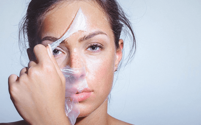 women is peeling the mask from her face 