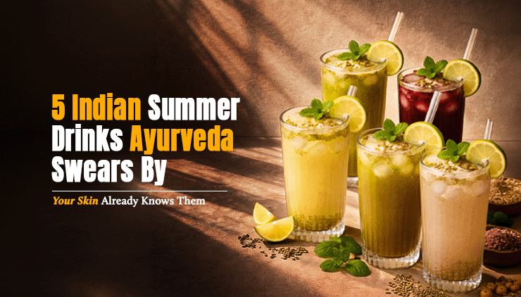 Five colorful drinks with herbs and lemon slices in glasses, casting shadows on a textured surface. Text: "5 Indian Summer Drinks Ayurveda Swears By."