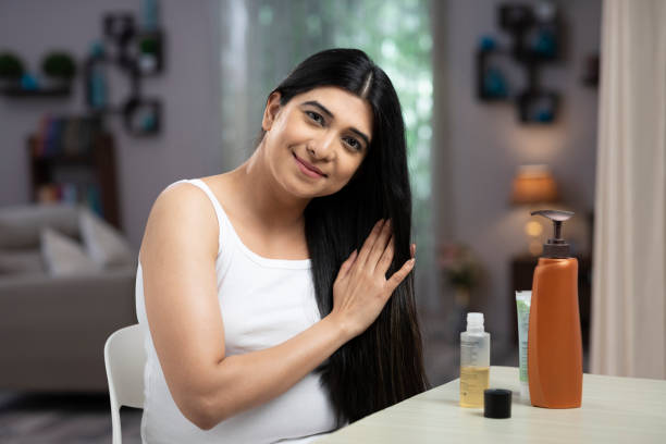 woman oiling hair