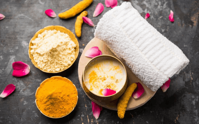 ubtan, gram flour, milk and cotton towel with rose petals 