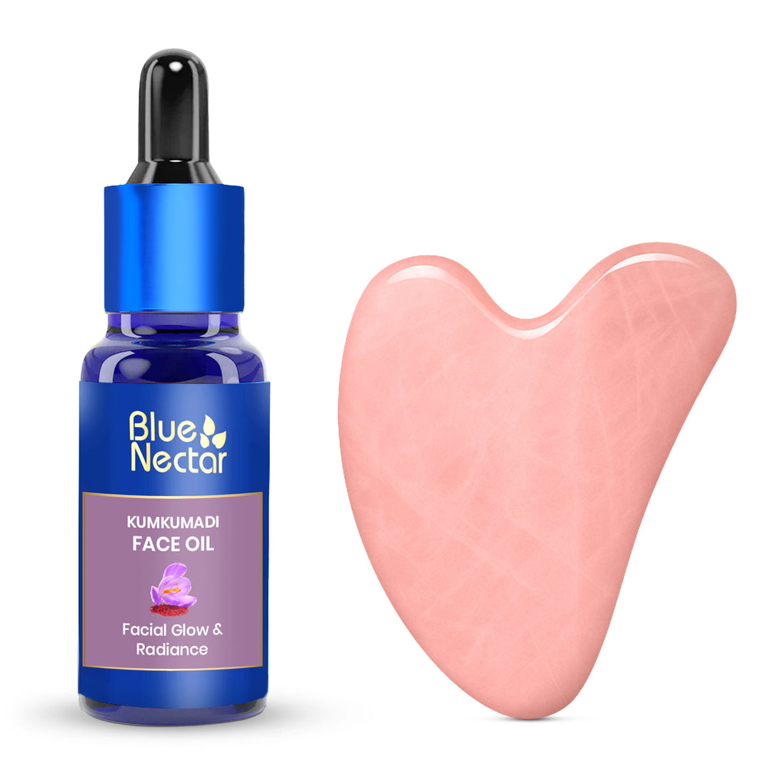 Kumkumadi Serum bottle with dropper and a Rose  Quartz Gua Sha tool beside it