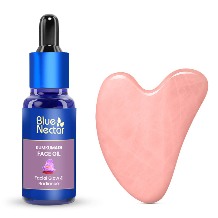 Kumkumadi Serum bottle with dropper and a Rose  Quartz Gua Sha tool beside it