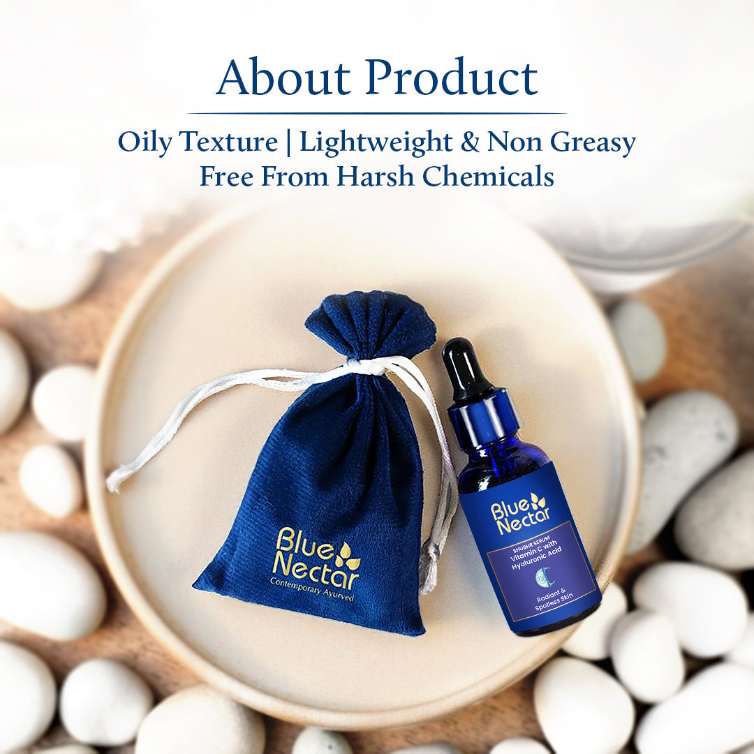 Vitamin C Serum with the bottle inside a cotton pouch, surrounded by stones.