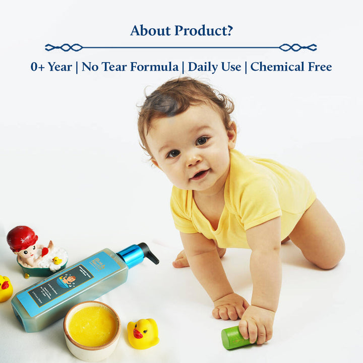 A baby joyfully plays with toys, glancing up with curiosity, while a bottle of baby shampoo sits nearby alongside a bowl of rich, golden ghee.
